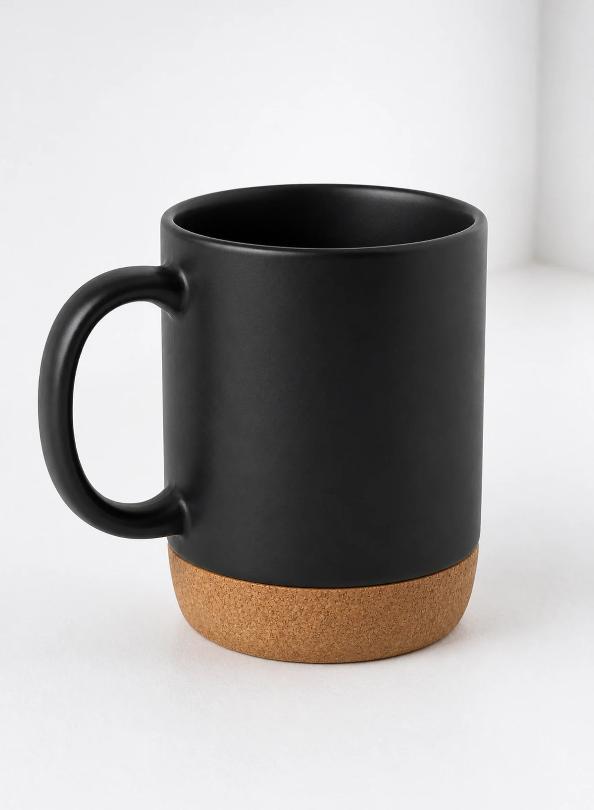 Cork Base Mug — Black, ceramic mug shown in a complementary studio setting
