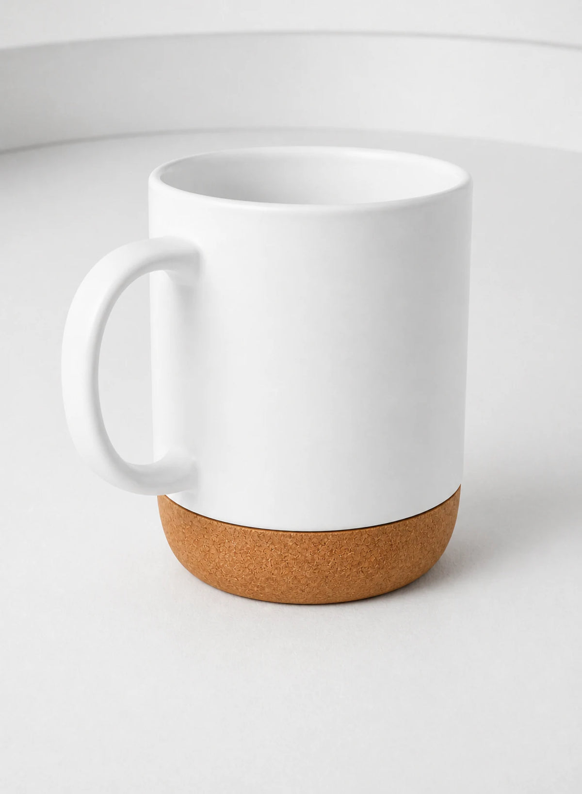 Cork Base Mug — White, ceramic mug shown in a complementary studio setting