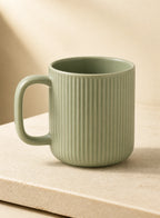 Ripple Ceramic Coffee Mug — Sage, ceramic mug shown in a complementary studio setting